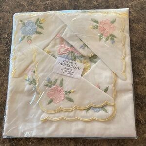 Vintage cotton table cloth with matching napkins. New old stock. Unopened